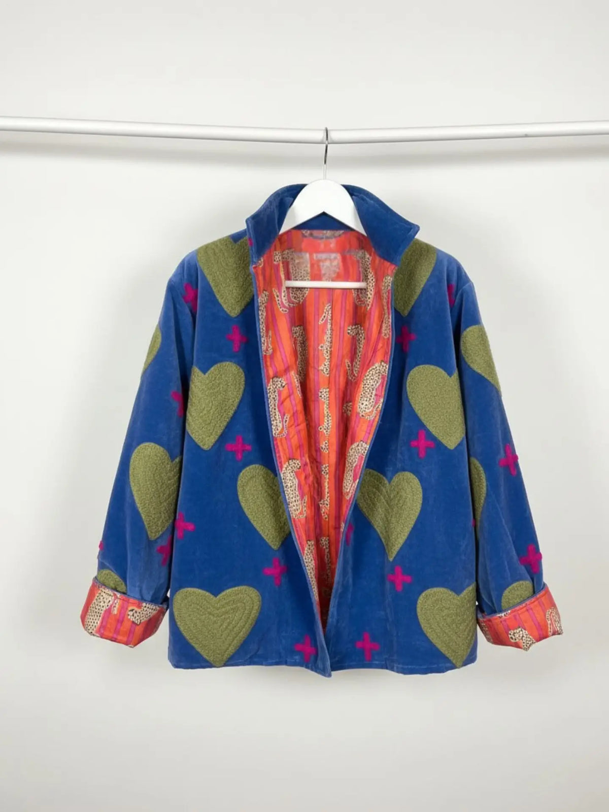 Blue coat with heart patterns on a white background