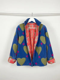 Blue coat with heart patterns on a white background