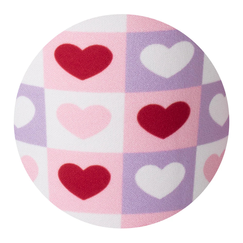 Round fabric close up with heart pattern on a white background
