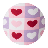 Round fabric close up with heart pattern on a white background